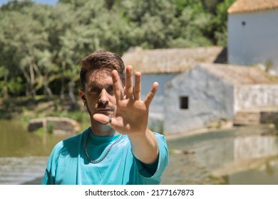 Young Man With Red Hair And Freckles, With An Open Hand Saying No, Nonconformist And Angry With Society For Not Finding A Job. Concept Anger, Reluctance, Rebelliousness, Youth, Unemployment.