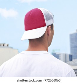 Young Man In A Red And White Trucker Hat, And White T-shirt. Blue Baseball Cap Mockup. Close-up