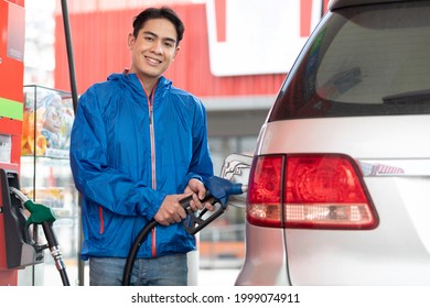 Young Man Refueling The Car At A Petrol Station