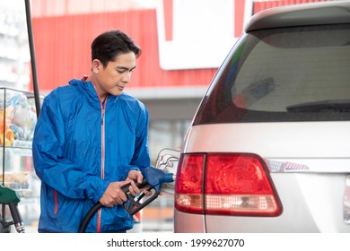 Young Man Refueling The Car At A Petrol Station