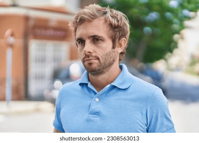 Young man with relaxed expression standing at street