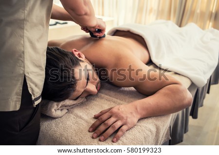 Similar – Image, Stock Photo Man relaxing during a chest massage at a spa with a serene expression.Wellness Hotel Concept image