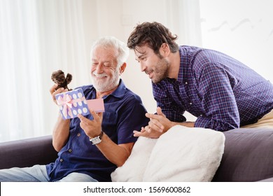 Young Man Returned Family Home During The New Year's Holiday With A Cute Gift Box To The Old Man, Elder Smiled And Was Very Happy With Teddy Present.