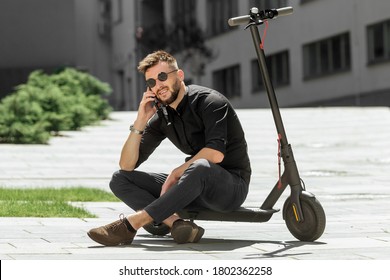 Young man riding electric scooter in urban background