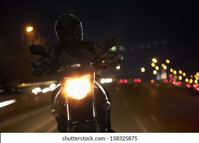 Young Man Riding Motorcycle At Night