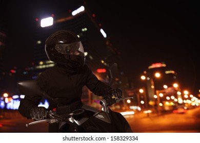 Young Man Riding Motorcycle At Night 