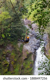 A Young Man Riding On A Zip Line Rope In An Extreme Adventure Jungle In Xico, Veracruz, Mexico