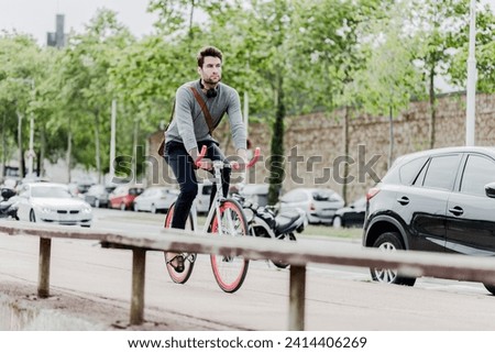 Young man riding racing cycle