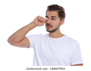 Young Man Rubbing Eye On White Background. Annoying Itch