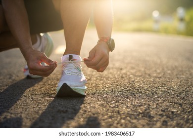 young man runner tying shoelaces - Powered by Shutterstock