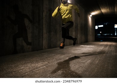 Young man running and exercising in a tunnel in the city - Powered by Shutterstock