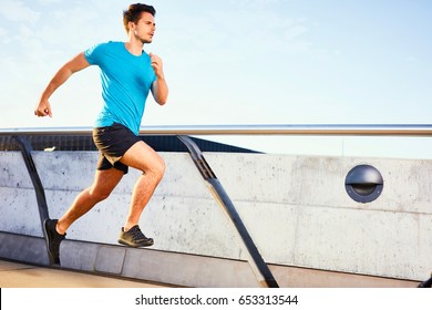 Young Man Running Fast On Bridge