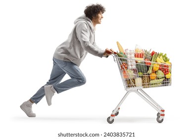 Young man running with food in a shopping cart isolated on white background - Powered by Shutterstock