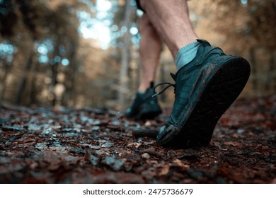 Young man running off road on a forest trail. Close up shot. - Powered by Shutterstock