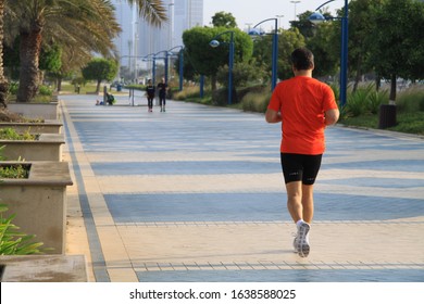 A Young Man Running On Abu Dhabi Corniche