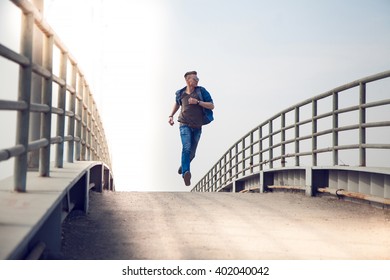 young man running on the bridge - Powered by Shutterstock