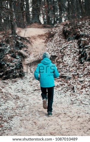 Young man running outdoors during workout in a forest