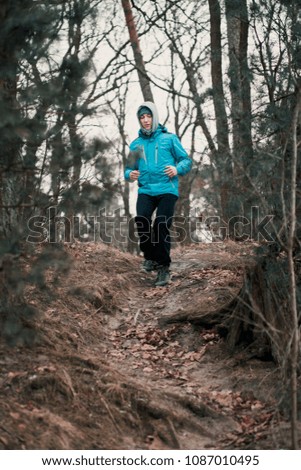 Similar – Young man running outdoors during workout in a forest