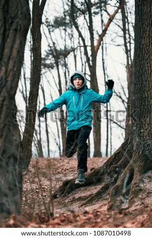 Similar – Young man running outdoors during workout in a forest