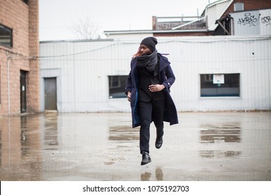 Young Man Running In The Rain