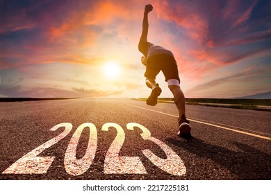 Young man running and sprinting on the road with new year 2023 concept