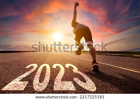 Young man running and sprinting on the road with new year 2023 concept