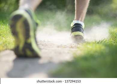 Young man is running in sunny nature