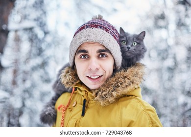 Young Man And Russian Blue Cat In Winter Forest