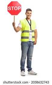 Young man in a safety vest with a stop traffic sign looking at camera and smiling isolated on white background