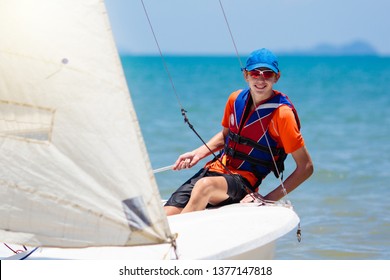 Young man sailing. Teenager boy on sea yacht. Healthy water sport. Yachting class for teen age sailor. Ocean vacation on boat. Regatta on tropical island. Beach and sail activity.