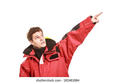 Young man sailor wearing red waterproof wind jacket showing pointing copy space blank isolated on white. Sailing yachting cruise. Studio shot. - Powered by Shutterstock