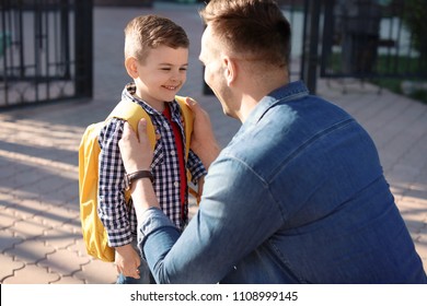 Young Man Saying Goodbye To His Little Child Near School