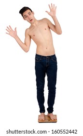 Young man scared because he is too skinny and the scale is showing he is too slim 
