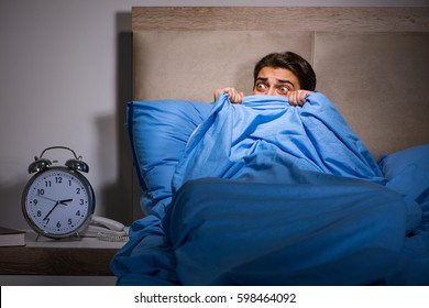 Young Man Scared In Bed