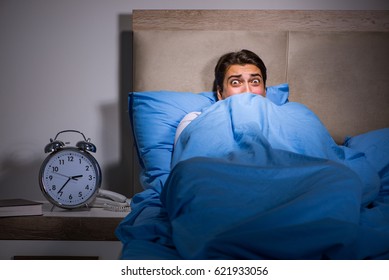 Young Man Scared In Bed