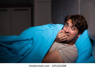 Young Man Scared In His Bed Having Nightmares