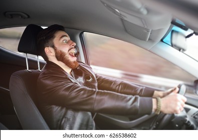 A young man scared screaming at the wheel of the car before the accident. Road traffic accident, collision on the road.
