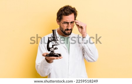 young man. scientist with microscope concept