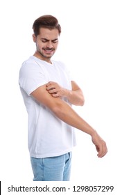 Young Man Scratching Arm On White Background. Annoying Itch