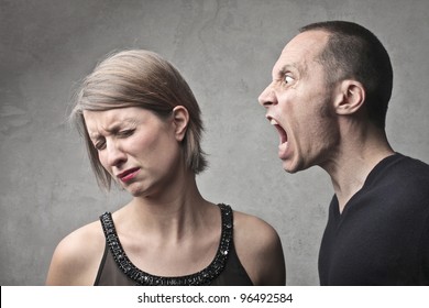 Young man screaming against a sad young woman