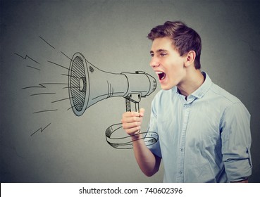 Young man screaming in a megaphone making announcement  