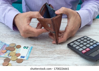 Young Man Searches His Wallet For Money During The Economic Cris