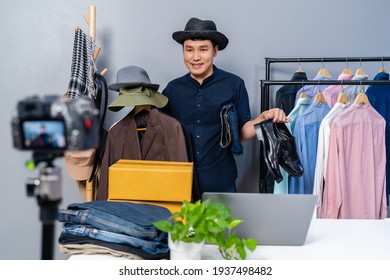 Young Man Selling Clothes And Accessories Online By Camera Live Streaming, Business Online E-commerce At Home