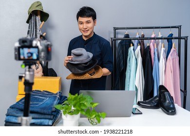 Young Man Selling Hat And Clothes Online By Camera Live Streaming, Business Online E-commerce At Home