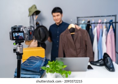 Young Man Selling Hat And Clothes Online By Camera Live Streaming, Business Online E-commerce At Home