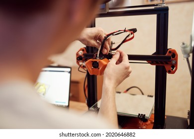 Young man set up 3d printer