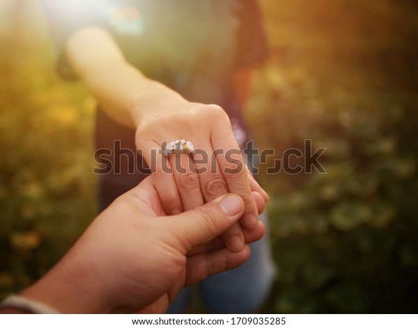A young man shakes hands with a young woman for\
getting married.