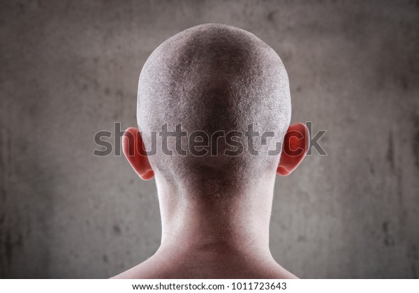 Young man with a shaved\
head