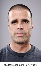 Young Man With Shaved Head Portrait In Studio