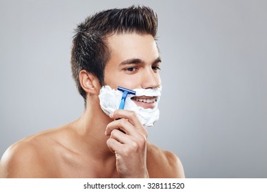 Young Man Shaving Beard